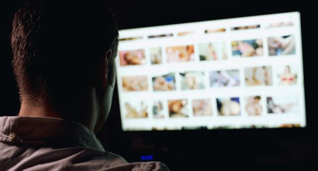 Man browsing porn site late at night.
